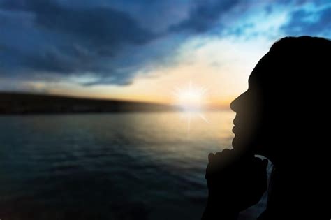 Premium Photo | Prayer. silhouette girl prays at sunset.