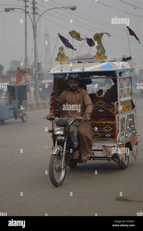 A motorcycle rickshaw decorated with perpetually nodding flags buzzes ...