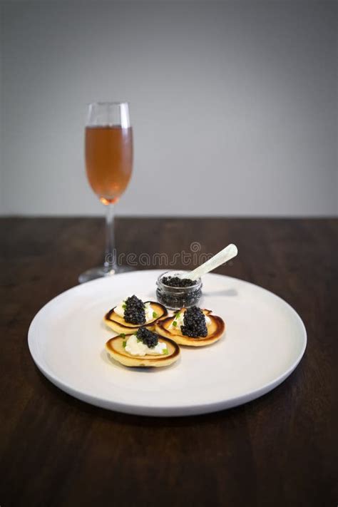 Russian Blini with Sturgeon Caviar, Full Jar and a Glass of Rose Champagne Stock Photo - Image ...