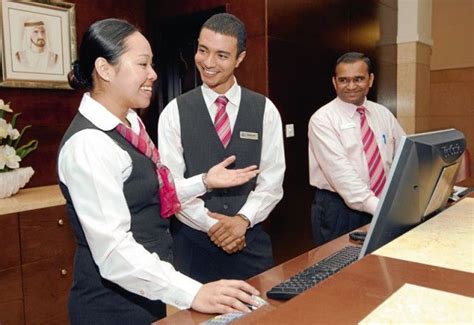 Front Desk Agents with black vests and coordinating scarf and tie ...