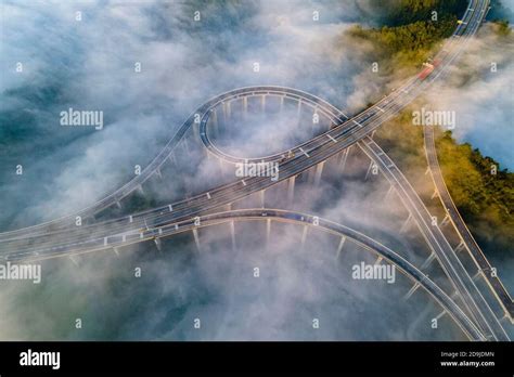 Aerial view of a highway enveloped in the cloud sea in Shijiachong ...