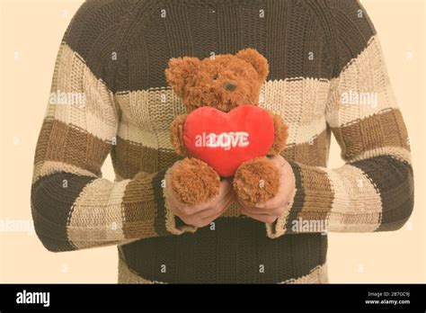 Hands of man holding teddy bear and ready for winter Stock Photo - Alamy