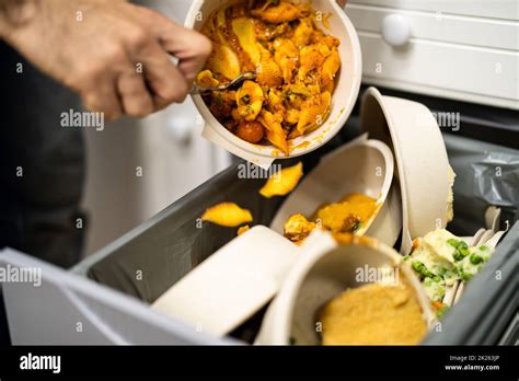 Throwing Away Leftover Food In Trash Stock Photo - Alamy