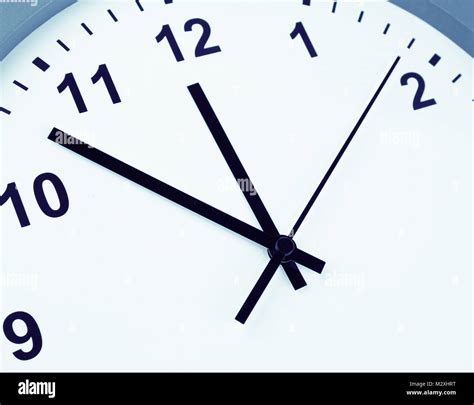 Closeup of hands on clock face Stock Photo - Alamy