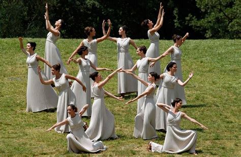 Ancient Greek priestesses perform a ritual dance, during the lighting of the flame ceremony, on ...