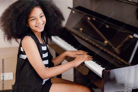 African black children playing piano music instrument happy smiling. Stock Photo | Adobe Stock