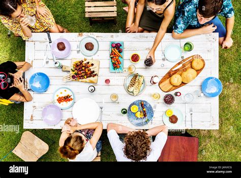 Aerial view of diverse friends gathering having food together Stock ...