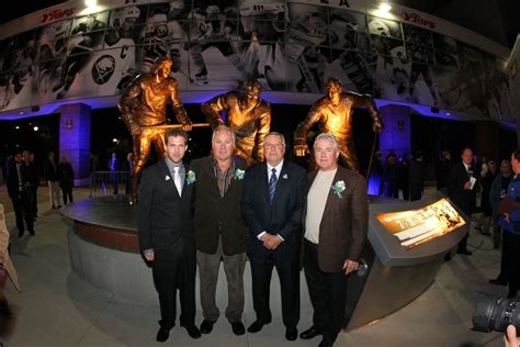 Cory Martin (son of Rick Martin), Gilbert Perreault, Terry Pegula and Rene Robert standing in ...