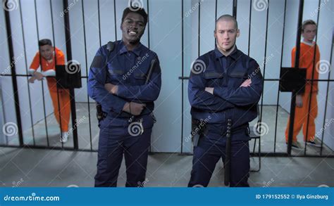 Prison Guards Stand Near Prison Cells Stock Photo - Image of grate ...