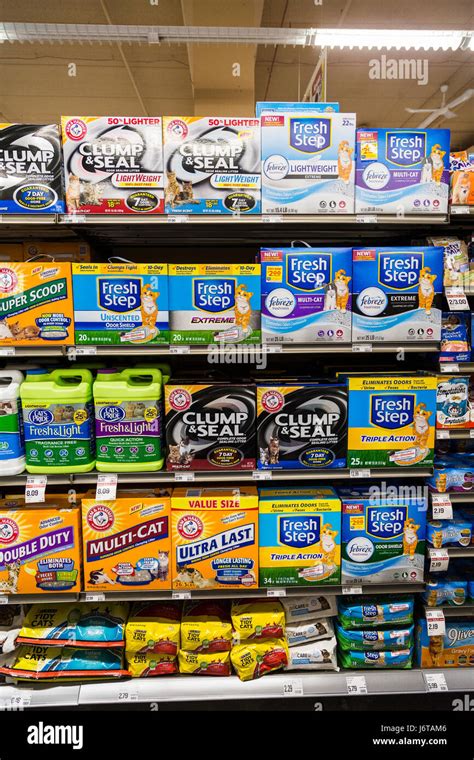 various brands of cat litter boxes on the shelves of a grocery store ...