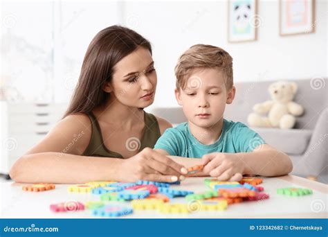 Young Woman and Little Boy with Autistic Disorder Playing Stock Photo ...