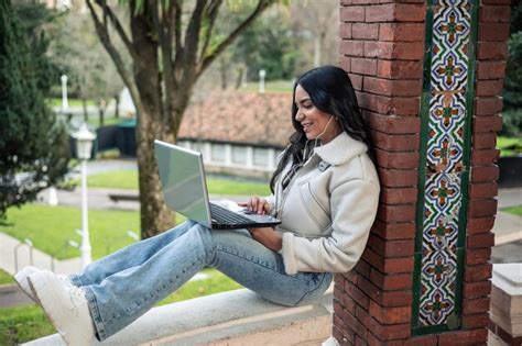 Premium Photo | Young latin girl working on laptop outdoors