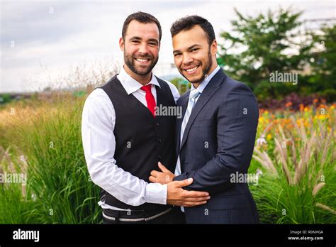 Handsome gay male couple in the park on their wedding day Stock Photo ...