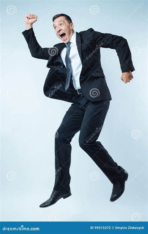 Delighted Emotional Man Jumping Stock Photo - Image of daytime, emotion: 99515372