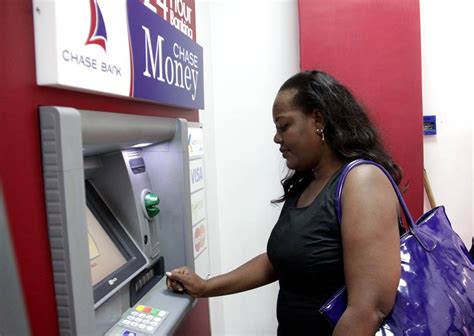 PHOTOS: Chase Bank Customers Flock The ATMs As Bank Re-Opens