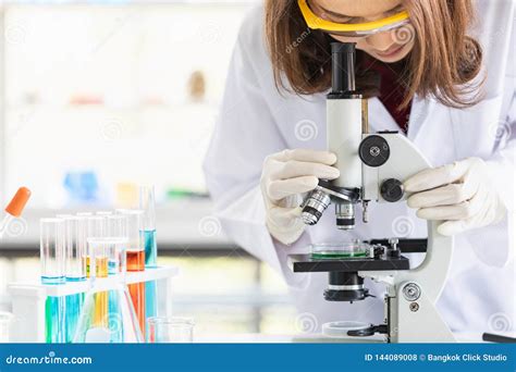 Scientist Look through Microscope for Experiment Stock Photo - Image of female, nanotechnology ...