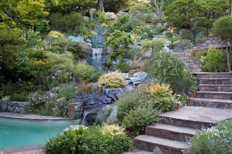 Swimming pool and hillside rock garden with waterfall - Asian ...