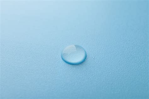 Premium Photo | Water drop on blue, macro and space for text