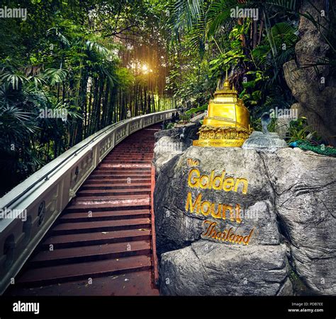 Golden Stupa statue in the tropical jungle near the stairs in Wat Saket Golden Mountain Temple ...