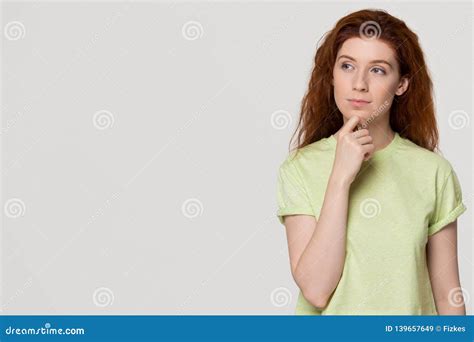 Thoughtful Doubtful Redhead Woman With Unsure Face Looking At Copyspace ...