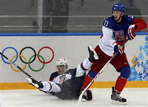 Czech Republic’s Michalek checks Team USA’s Brown into the boards during the second period of ...