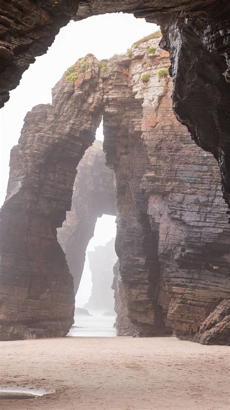 Natural rock arches on Cathedrals beach in low tide, Praia As Catedrais ...