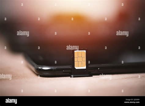 SIM card for smart phone. Changing the SIM card Stock Photo - Alamy