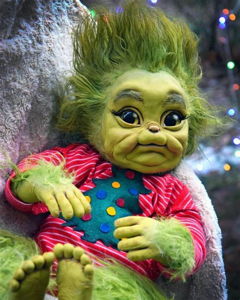 Download Baby Grinch In Onesies Christmas Attire Wallpaper | Wallpapers.com