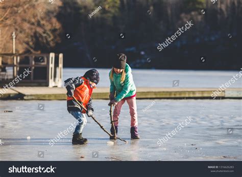 Two Adorable Kids Playing Ice Hockey Stock Photo (Edit Now) 1316626283