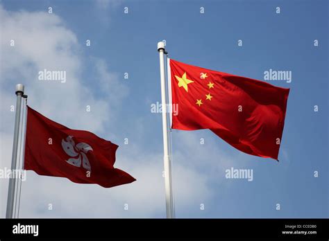 hong kong and chinese flags flying with hong kong flag in shade Stock Photo - Alamy
