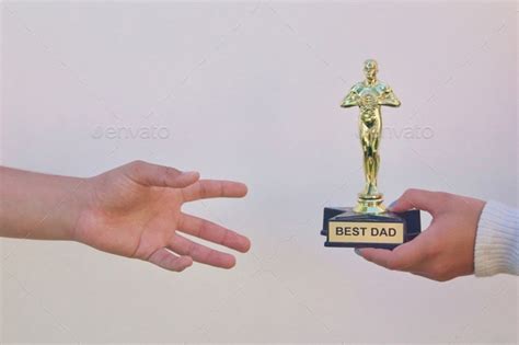 Father's Day image of a daughter giving a Best Dad award trophy to her ...