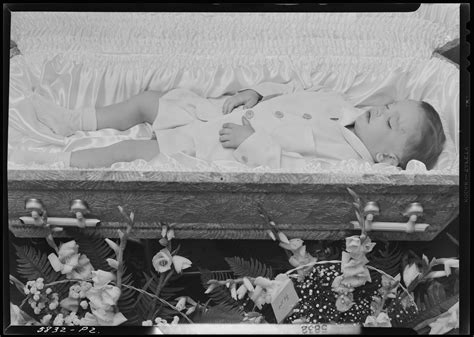 Jackie Hall; corpse of little boy; open casket surrounded by flowers