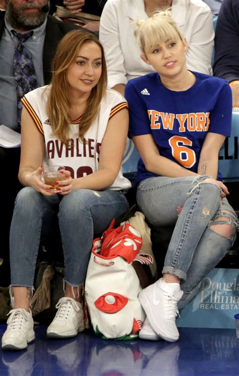 Miley Cyrus with sister Brandi at the Knicks game -05 | GotCeleb