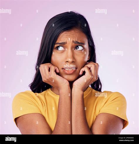 Scared, worry and face of Indian woman on pink background with fear, nervous and confused ...