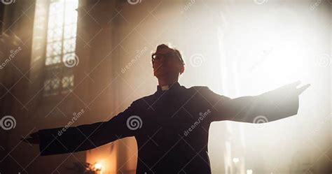 Portrait of Christian Priest Raising Hands in Blessing His Congregation while Praying in Church ...