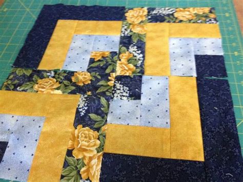 a quilted table runner with yellow flowers on it