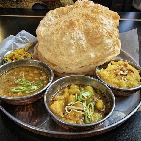 Halwa Poori platter with chickpeas potatos and halwaa. Most important meal of the day. @chaaye ...