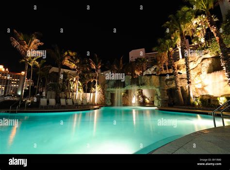 A resort swimming pool at night Stock Photo - Alamy