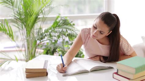 Student Girl Studying At Table With Books And Smiling Stock Footage Video 4463993 - Shutterstock