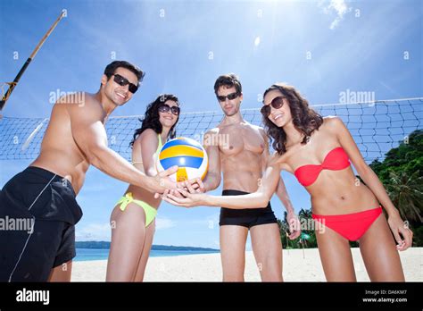 Friends playing beach volleyball Stock Photo - Alamy