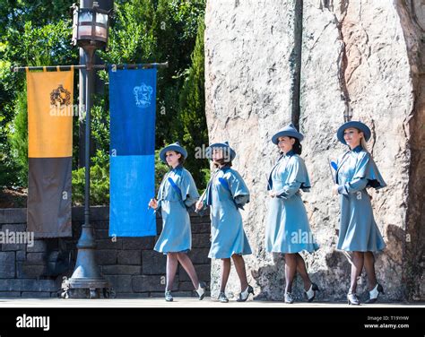 4 Beauxbatons female dancers, students onstage outdoors at the Wizarding World of Harry Potter ...