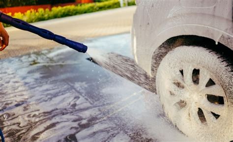 Premium Photo | Foaming the car with the foam car wash man washing car ...