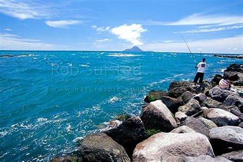 Sea Fishing at the entrance to Whakatane River. Motuhora (Whale) Island behind, Whakatane ...