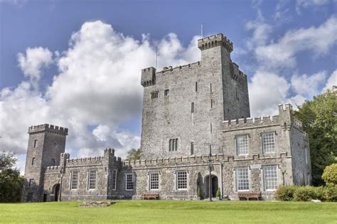 an old castle sitting in the middle of a lush green field under a ...