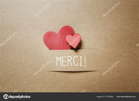 Merci - Thank you in French language with small hearts Stock Photo by ...