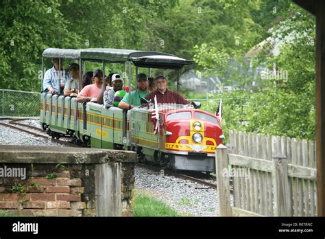 Adults riding miniature train in public park, U.S.A Stock Photo - Alamy