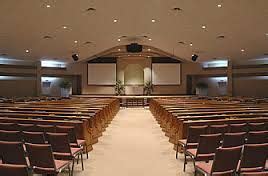 Stacking chairs and two screen in this simple auditorium worship space ...