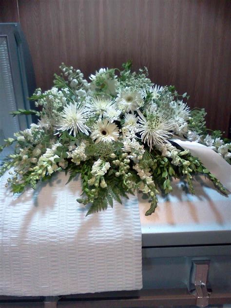 a bouquet of white flowers sitting on top of a table