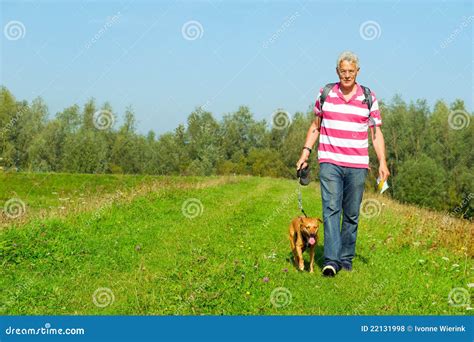 Hiking man with dog stock photo. Image of grey, grass - 22131998