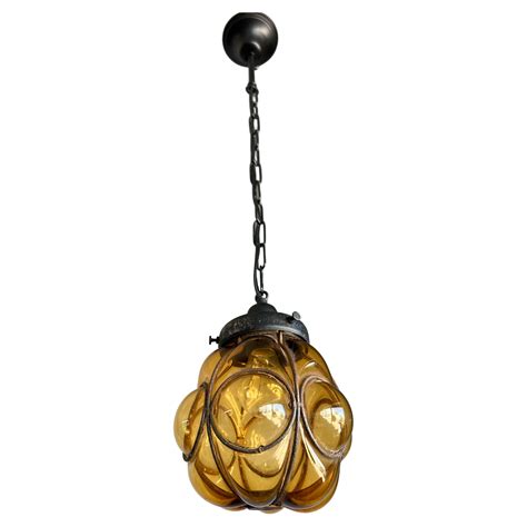 Small Antique Venetian Murano Pendant, Glass Mouth Blown into Wrought Iron Frame For Sale at 1stDibs